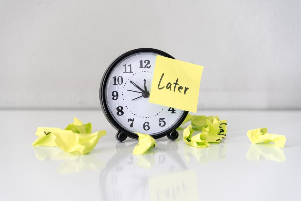 A clock with sticky notes that say "later" on them