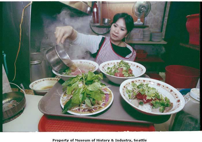 Theresa Vu preparing bowls of pho at Pho Bac restaurant.jpeg