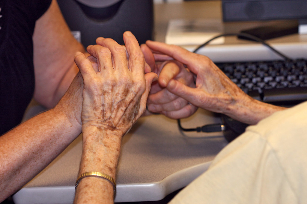 Two people communicating in tactile sign language