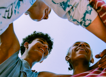 Youths circling together, smiling