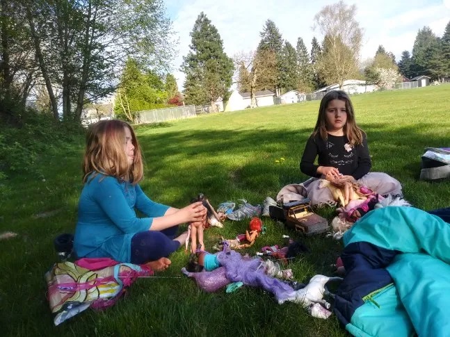 Madeline Matyas, 7, left, and her sister Gabrieal, 6, play with their toys at a park in Sedro-Woolley, Washington, on an April afternoon. Their family of four often walks to the park since schools shut down in Washington in March. (Matyas, 2020)