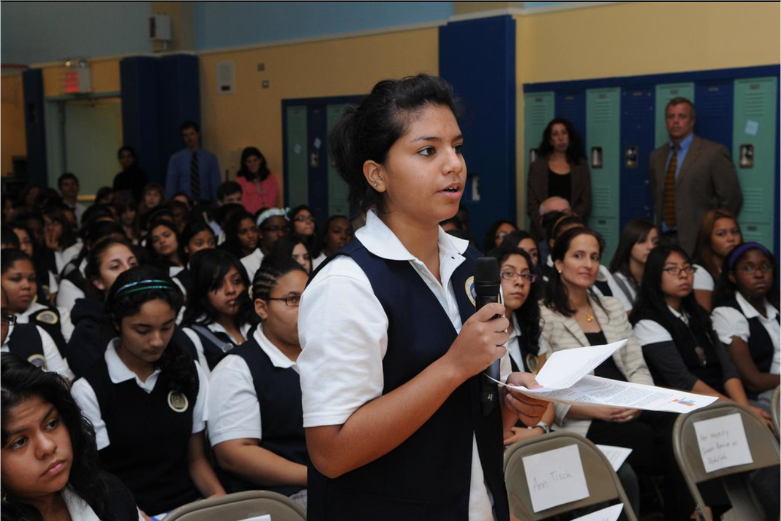 Pictured is a girl speaking at a conference where the organization provides college access programmes for low-income public school students across the country (UNICEF, 2011).